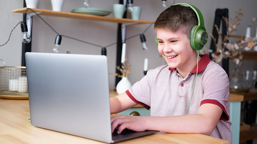 Student reading on a laptop at home.