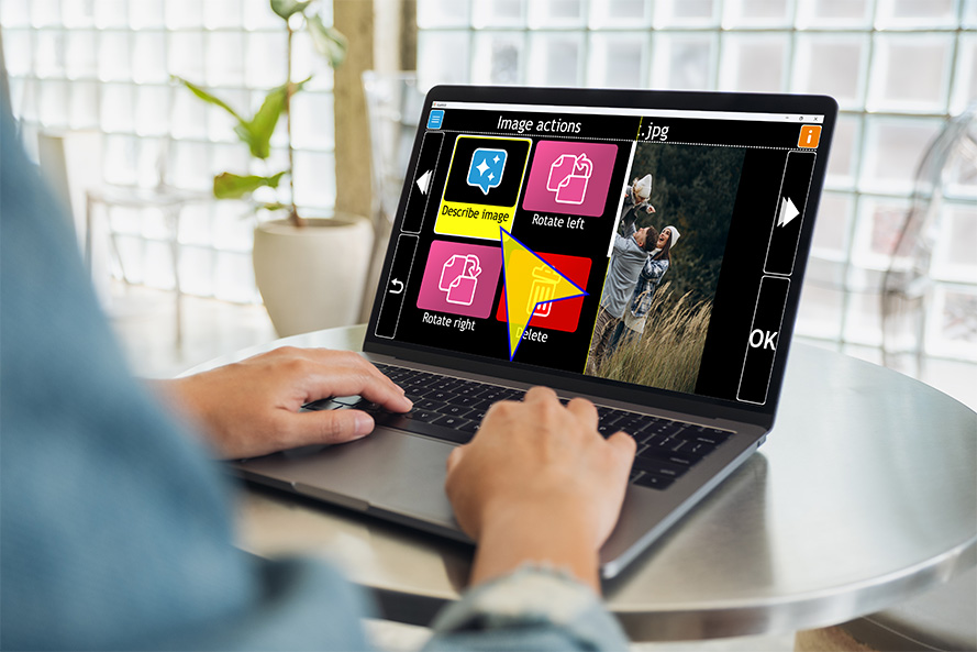 Shows a person using GuideConnect on a laptop - they are selecting the 'Describe Image icon in the actions Menu