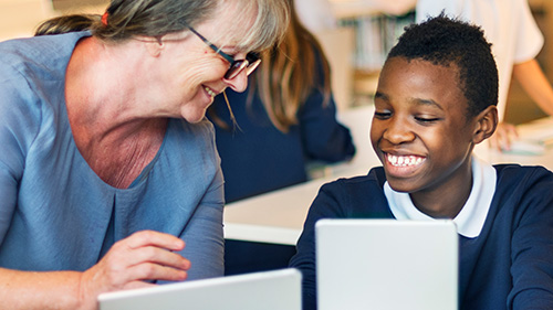Teacher and Student smiling as they use EasyReader on tablets in class