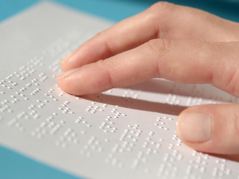 Close up of braille document and hand