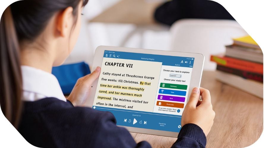 Secondary school student holding an ipad and wearing an earbud is smiling in class.