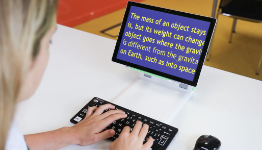 Student typing, with SuperNova magnification on screen
