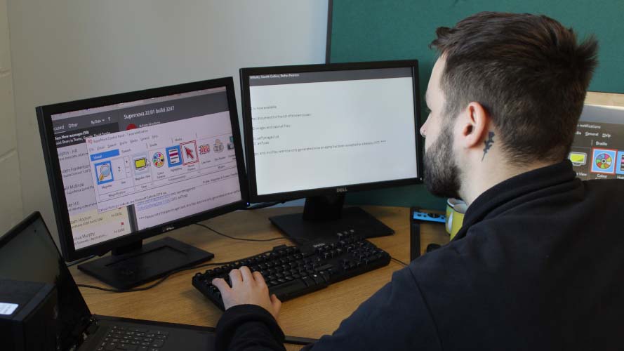 Kieran working at his computer screens